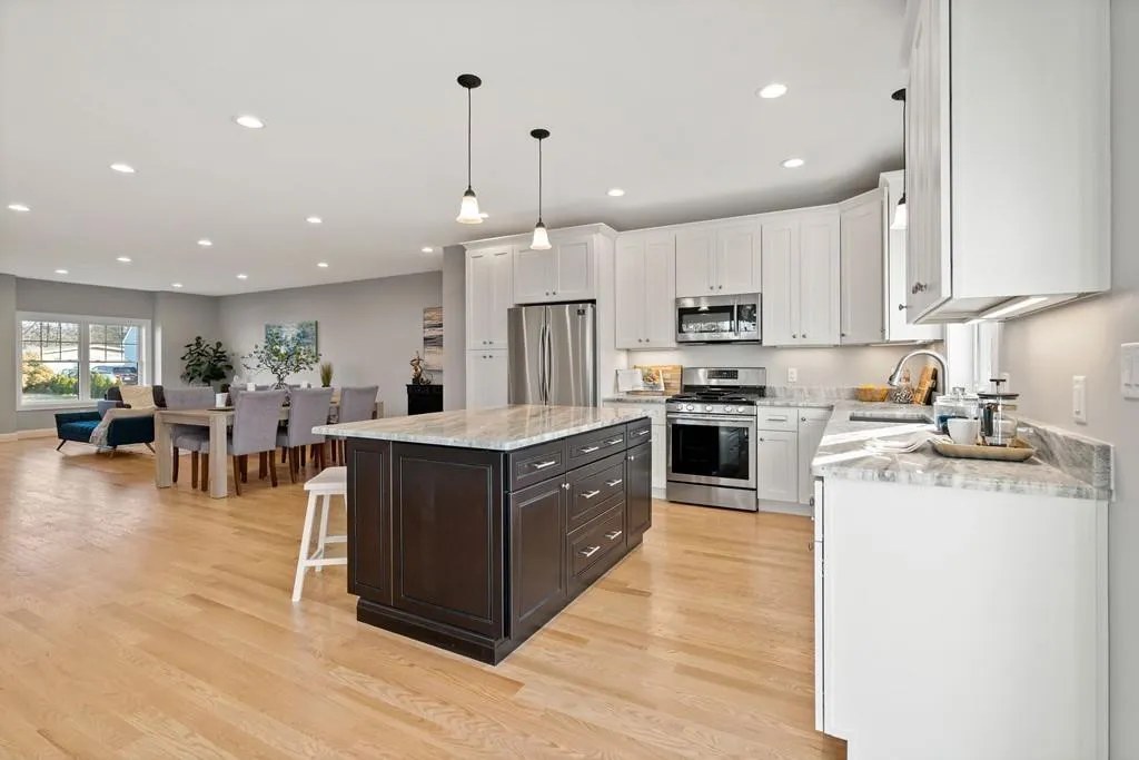 Kitchen island with granite countertops and pendant lighting in Wakefield, MA
