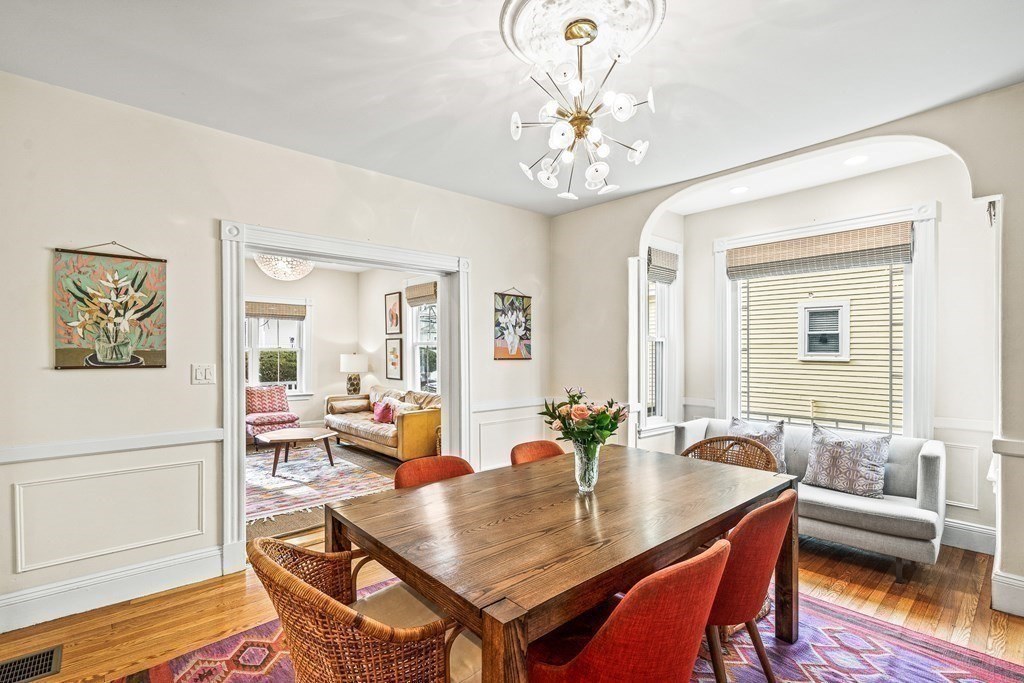 Dining room with cased openings and wainscoting in Melrose, MA