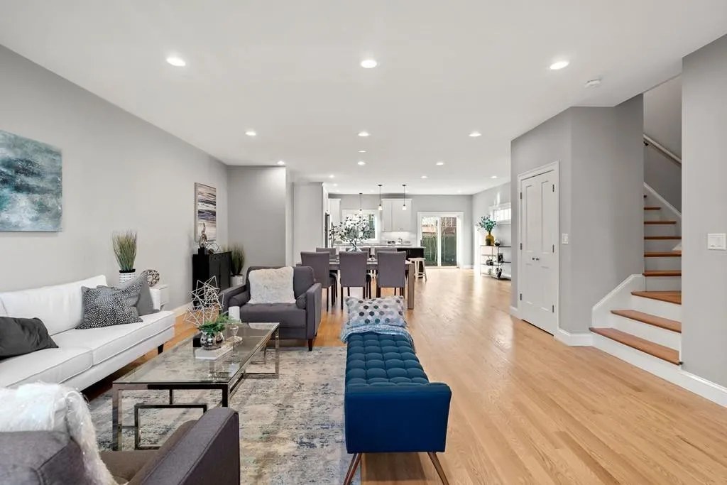 Open-concept living and dining area with hardwood flooring in Wakefield, MA